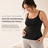 Woman wearing the black Relievoo postpartum support belt over a black vest top, holding the front support strap rvpumpen rvhasar