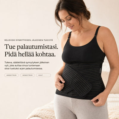 Woman wearing the black Relievoo postpartum support belt over a black vest top, holding the front support strap rvpumpen rvhasar