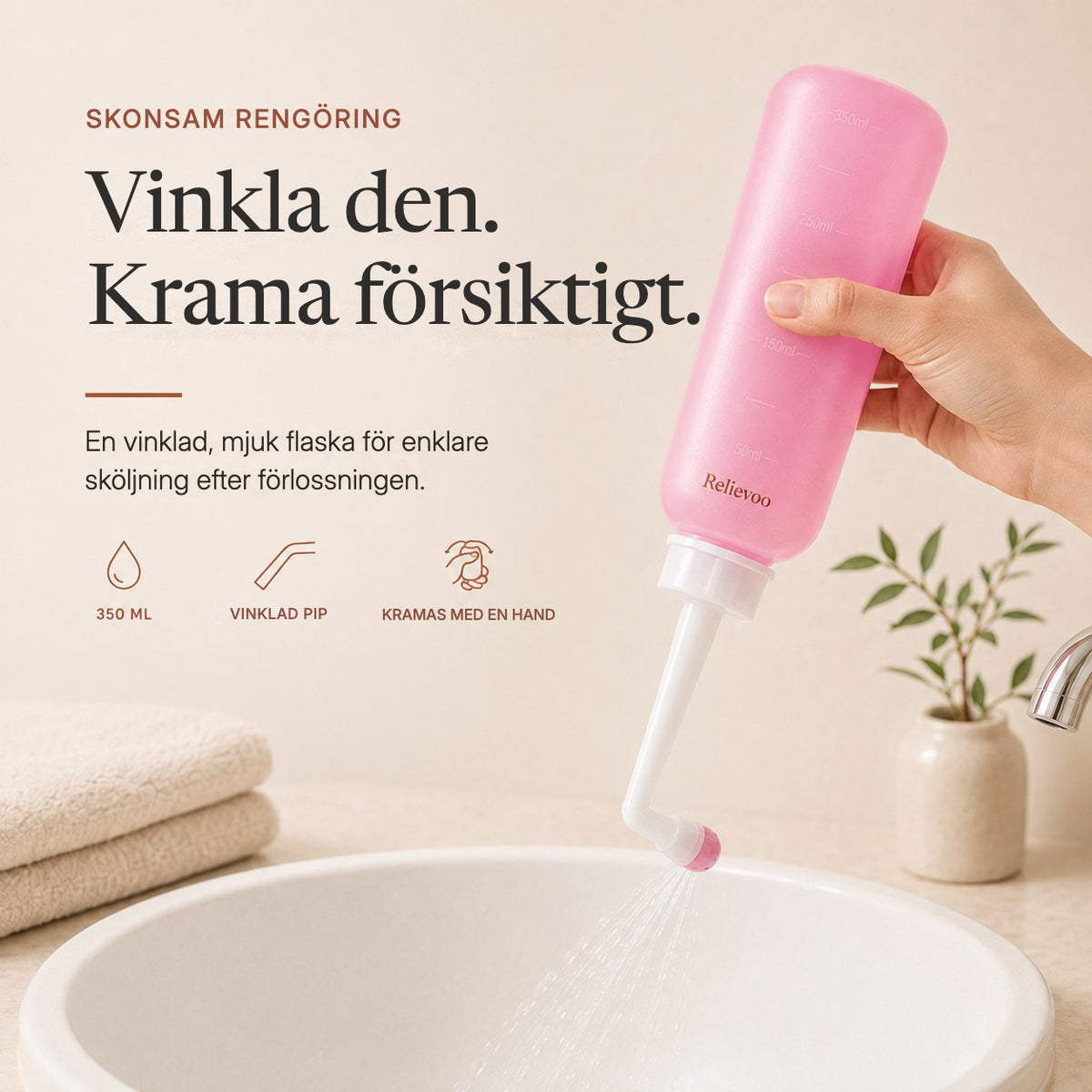 Hand squeezing the pink 350 ml Relievoo peri bottle with its angled nozzle over a basin rvpumpen rvhasar