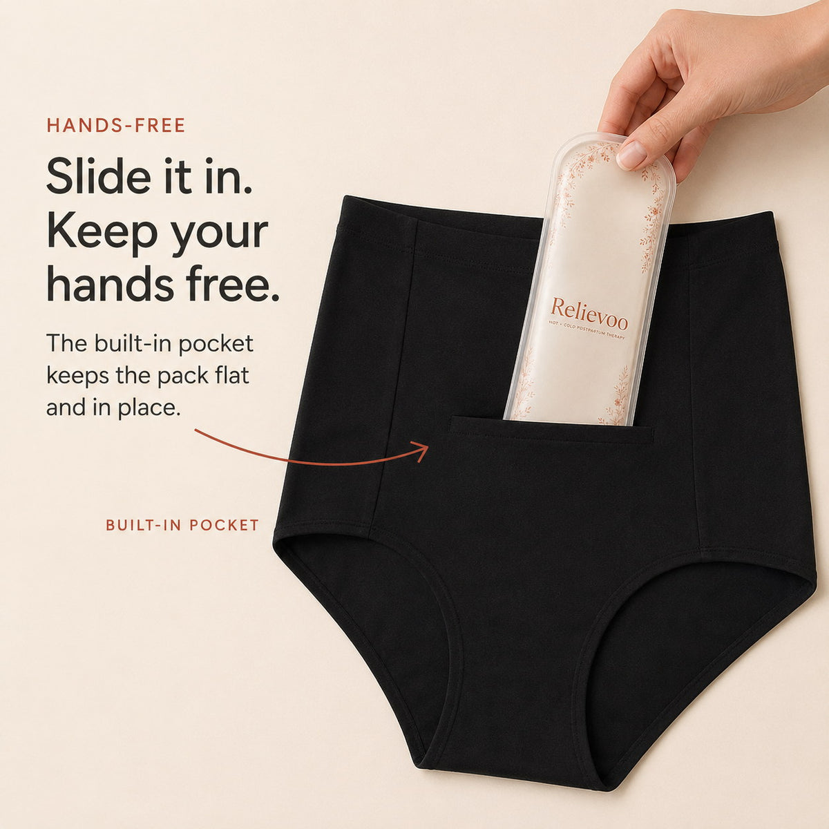 Hand sliding the Relievoo therapy pack into the built-in front pocket of black postpartum briefs rvpumpen rvhasar