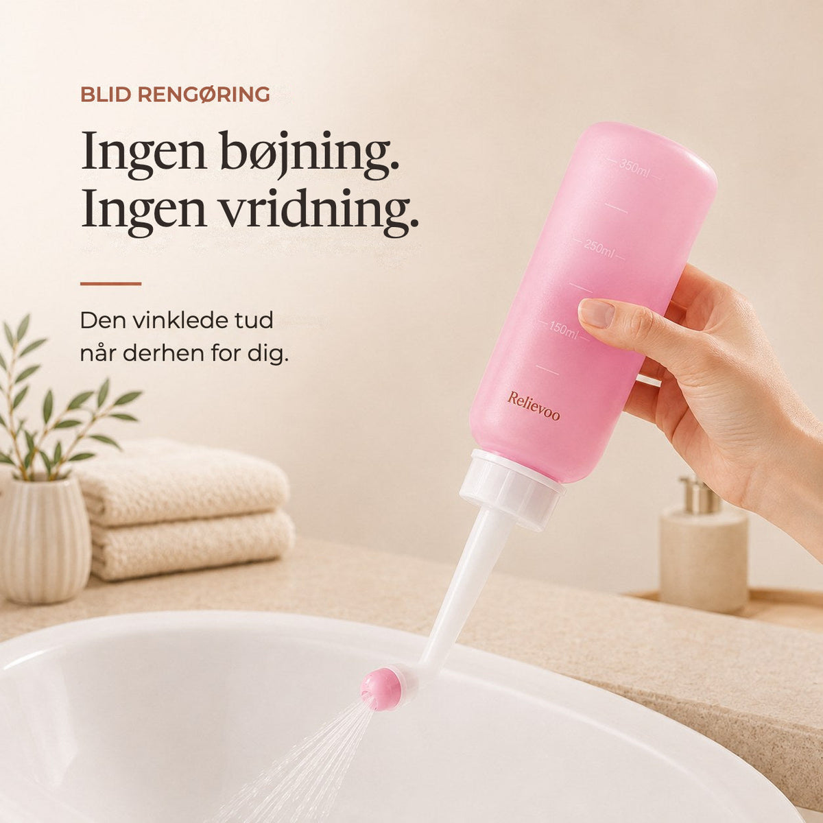Hand holding the pink 350 ml Relievoo peri bottle with its angled nozzle over a basin rvpumpen rvhasar