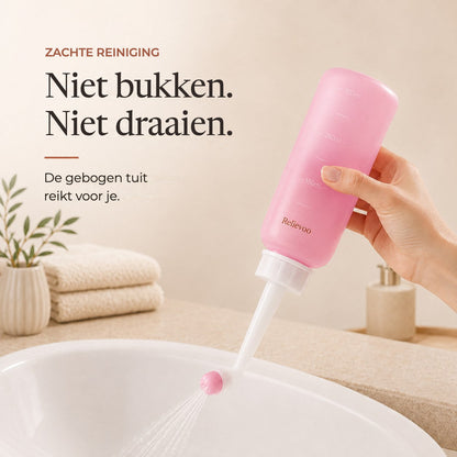 Hand holding the pink 350 ml Relievoo peri bottle with its angled nozzle over a basin rvpumpen rvhasar