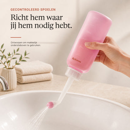 Hand holding the Relievoo peri bottle upside down and rinsing over a basin rvpumpen rvhasar