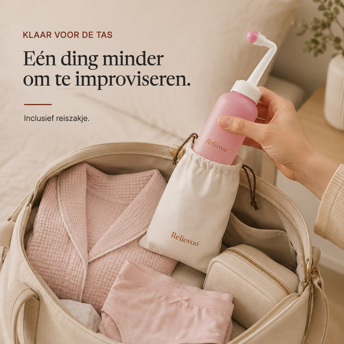 Hand slipping the Relievoo peri bottle into its travel pouch inside a packed hospital bag rvpumpen rvhasar